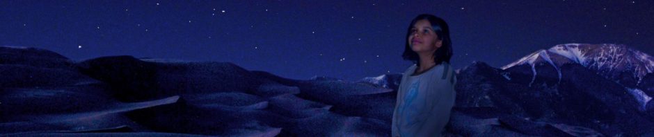 Girl Gazing at Night Sky at Base of Dunes